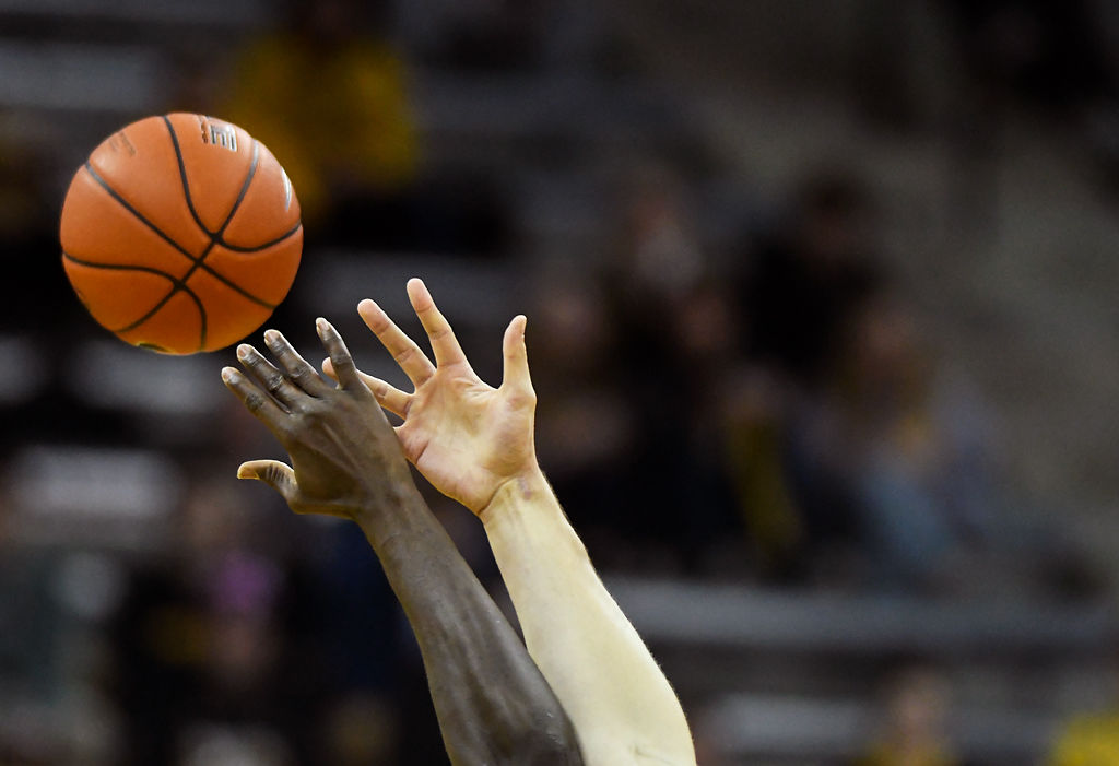 Missouri's Reed Nikko and Ole Miss' Khadim Sy jump for the first tip